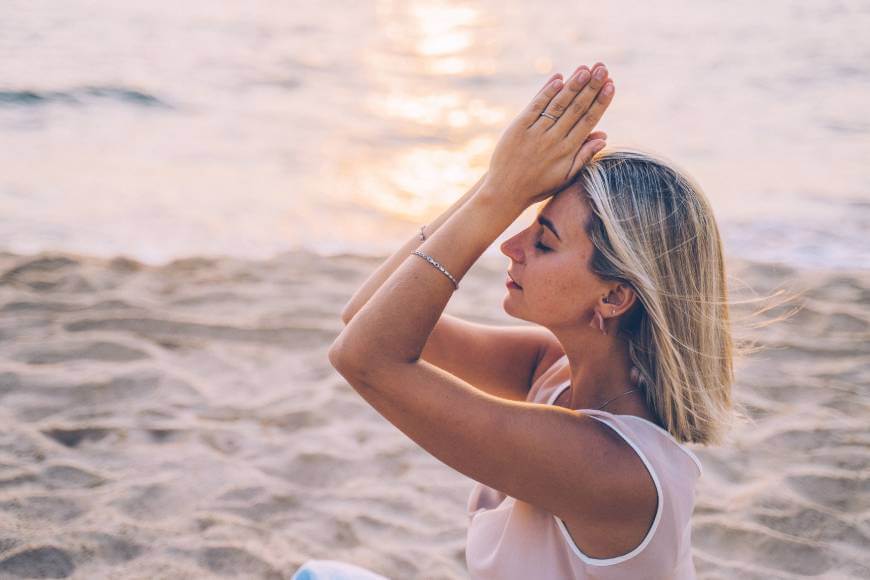 Doing yoga on beach