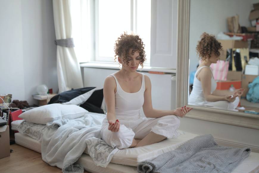 Doing yoga on sleeping bed