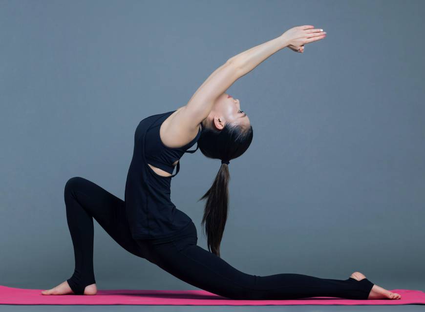 A girl wearing a legging is stretching
