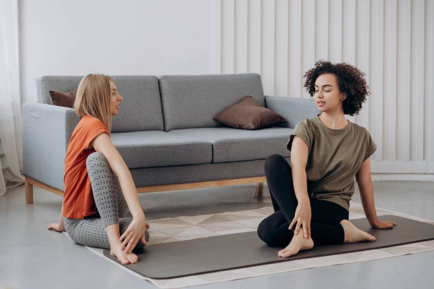 Two people are doing yoga